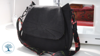 All black bag with cat features sewn on.
